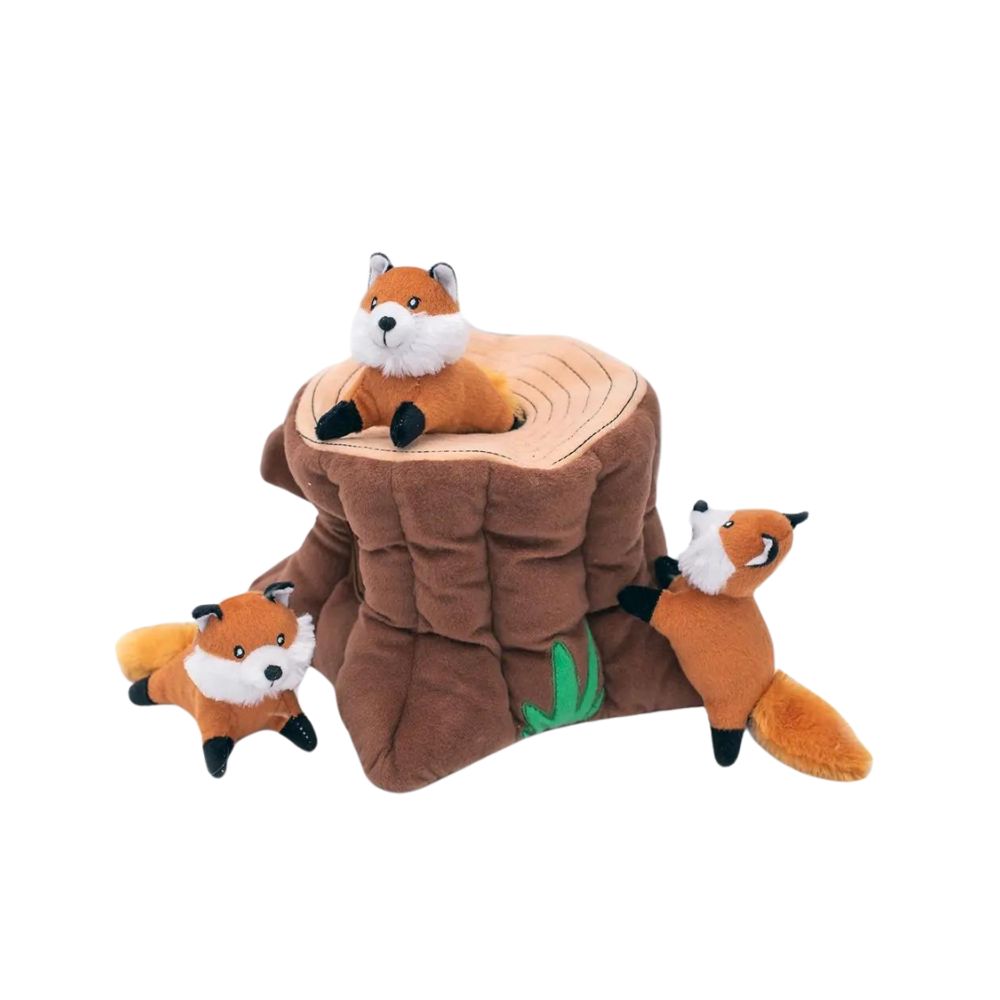 Three playful squeaky foxes with a plush Zippy Burrow fox stump designed for interactive hide-and-seek dog games.