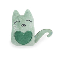 Close-up view of a green catnip toy with embroidered closed eyes, whiskers, a small nose, a green heart on its body, and a curled tail. Made from plush material.