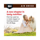 Woman feeding a Collie dog Black Hawk Air-Dried nutrition, highlighting its use as a complete meal, topper, or high-value training reward.