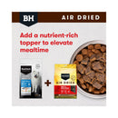 Graphic showing Black Hawk Original Fish and Potato kibble paired with Air-Dried Beef and Mackerel as a nutrient-rich meal topper for adult dogs.
