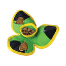 A green and yellow KONG Ballistic Hide 'N Treat dog toy with black Velcro pockets, shown on a white background with kibble and treat pieces inside.