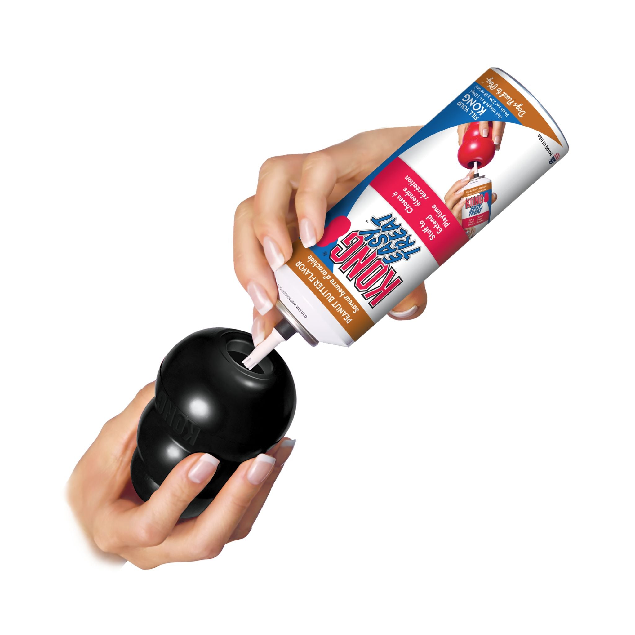 KONG Easy Treat is being stuffed into a black KONG Extreme Treat-Dsipensing dog toy.