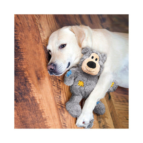 Golden Labrador snuggling with KONG Wild Knots Bear Dog Toy in Grey – soft and comforting plush companion
