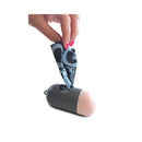 Human hand pulling a waste bag from the M-PETS waste bag dispenser on a white background