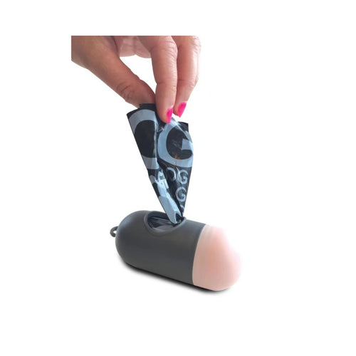 Human hand pulling a waste bag from the M-PETS waste bag dispenser on a white background