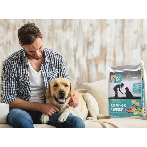 Meals for Mutts Salmon & Sardine – Gluten Free Dry Dog Food bag beside a happy man and dog
