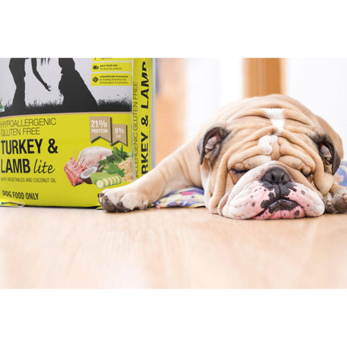 Meals for Mutts Turkey and Lamb Lite adult dry dog food bag beside a sleeping dog