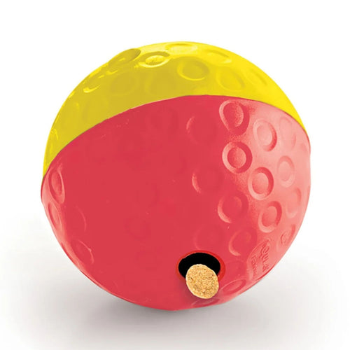 Nina Ottosson Treat Tumble dog puzzle ball, Large, red and yellow, with a treat in one of the dispensing holes.