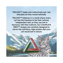Cat sitting in front of a mountainous landscape with promotional text about TRILOGY cat food.