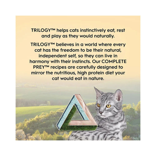 Advertisement for TRILOGY cat food with a grey cat and scenic background