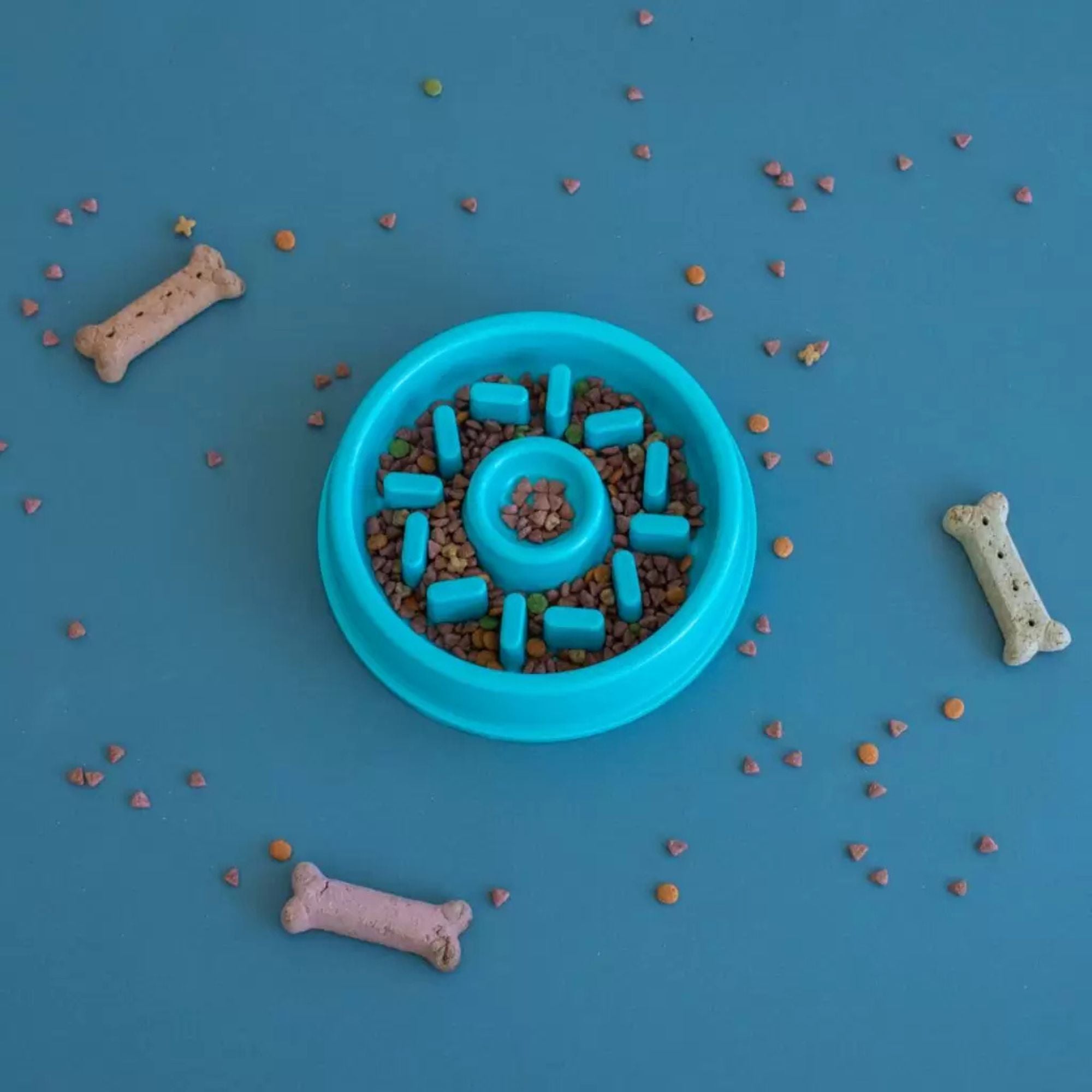 ZippyPaws Happy Bowl Donut slow feed bowl filled with kibble, styled with dog treats