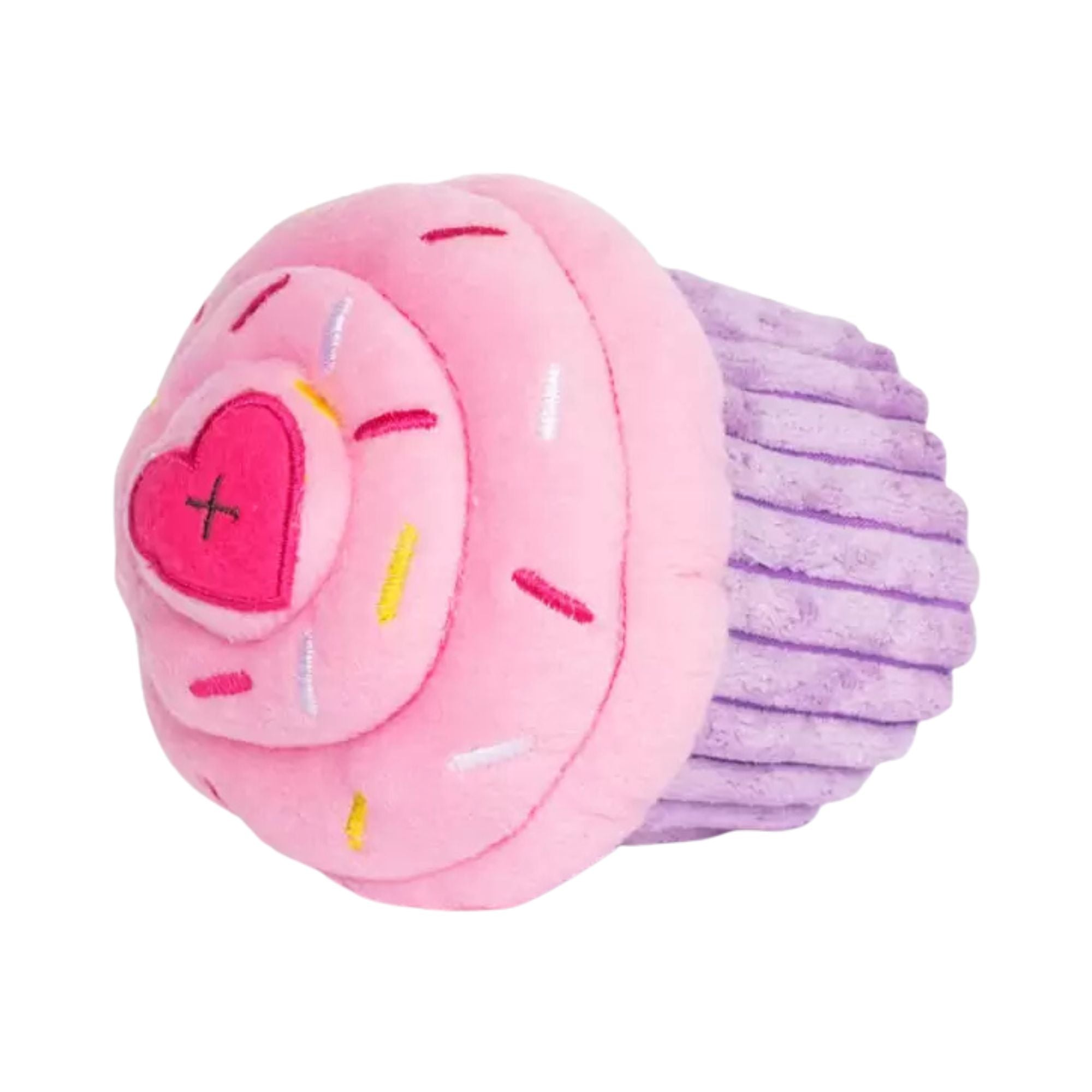 Side view of the pink NomNomz Cupcake plush toy showing the purple ridged base and pink frosting top with a heart accent.
