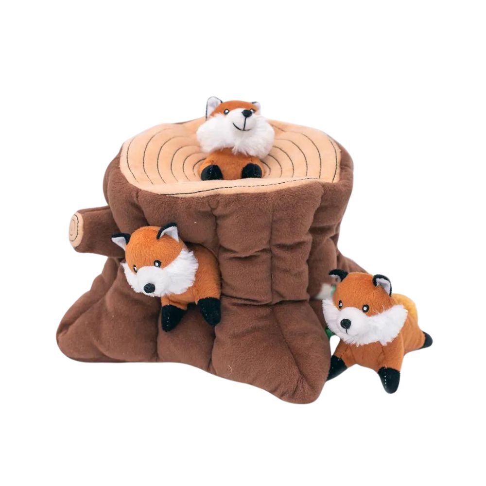 Interactive Zippy Burrow Fox Stump dog toy with three plush foxes peeking out from the holes, inviting playful dogs for a game of hide-and-seek.