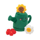 ZippyPaws Zippy Burrow Watering Can plush dog toy with a yellow sunflower peeking out of the green watering can, alongside a red flower and a white daisy squeaky flower.