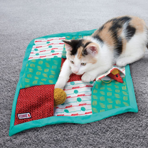 Cat playing with KONG Cat Puzzlements Pockets – interactive puzzle toy with crinkle fabric and hidden treat pockets for mental stimulation.